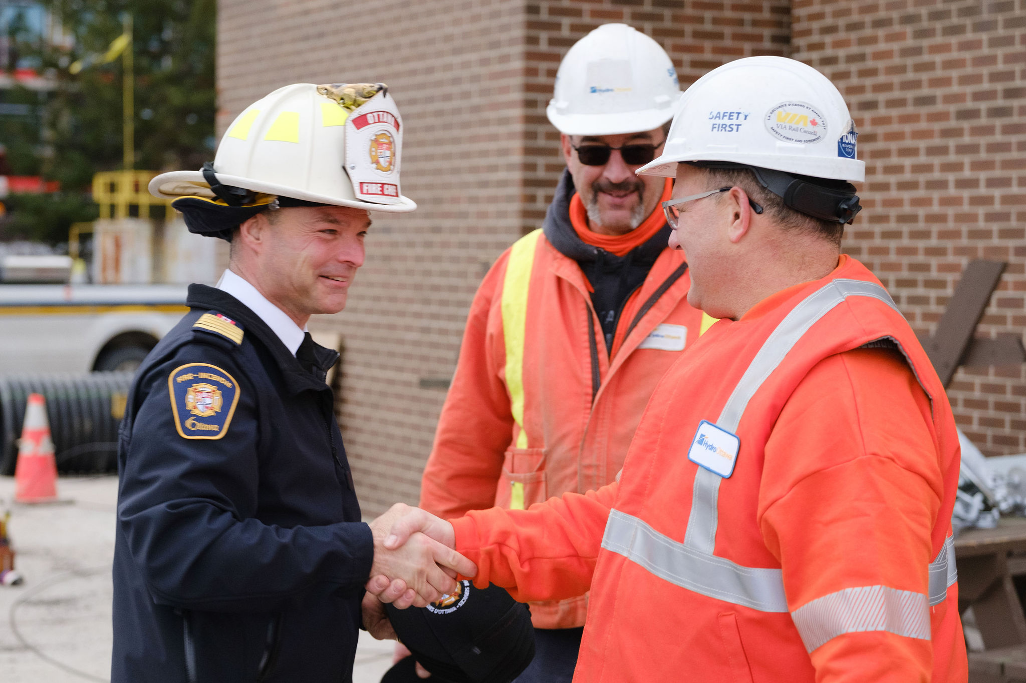 Ottawa Fire Chief, Paul Hutt, and Hydro Ottawa's Manager of Distribution shake hands