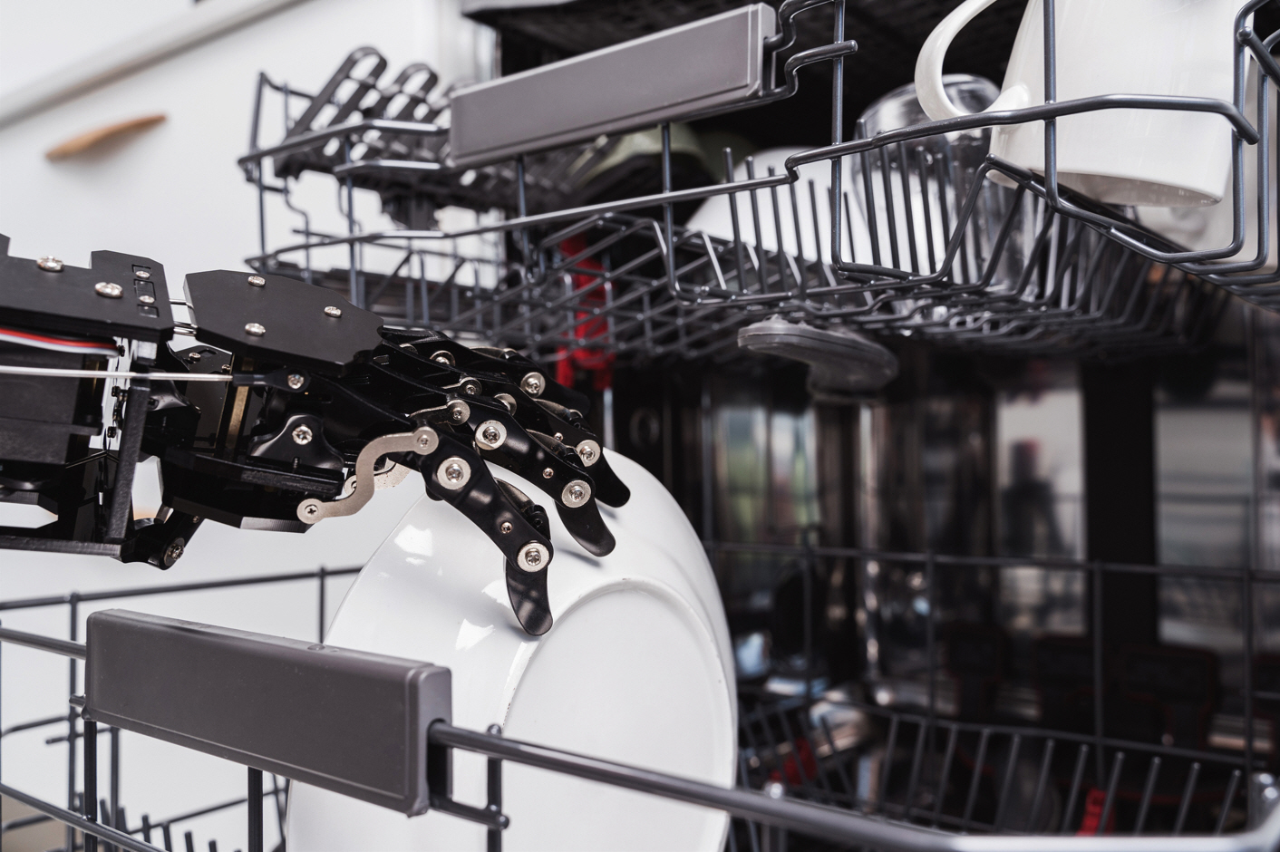 A robotic hand empties a dishwasher