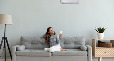 woman sitting on sofa in home