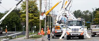 Hydro Ottawa power line maintainer in an aerial bucket