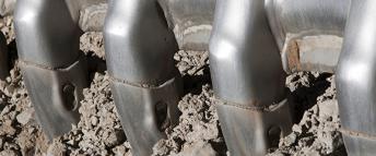 Loader bucket's teeth on the ground