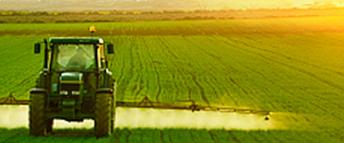 A farm tractor moving through a field.