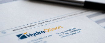 Close up of a pen on top of a Hydro Ottawa electricty bill