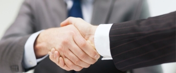 Two businessmen shaking hands in the office