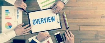 Overhead view of people around a table working on corporate overview