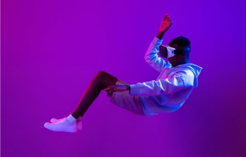 A man floats in air wearing a virtual reality headset