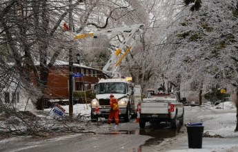 Hydro Ottawa crews work on an icy residential street during the 2023 Ice Storm