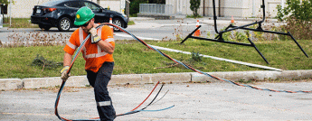 Collage showing crew members working to fix broken energy poles on the streets after the tornado