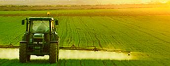 A farm tractor moving through a field.