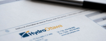 Close up of a pen on top of a Hydro Ottawa electricty bill