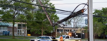 A hydro worker and police officer on scene after the May storm