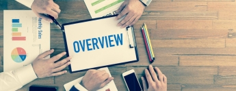 Overhead view of people around a table working on corporate overview