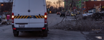 A white Hydro van appears next to a downed power line