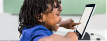 Kid plays on iPad in classroom