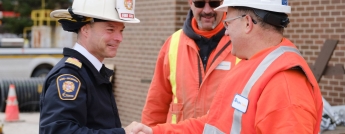 Ottawa Fire Chief, Paul Hutt, and Hydro Ottawa's Manager of Distribution shake hands